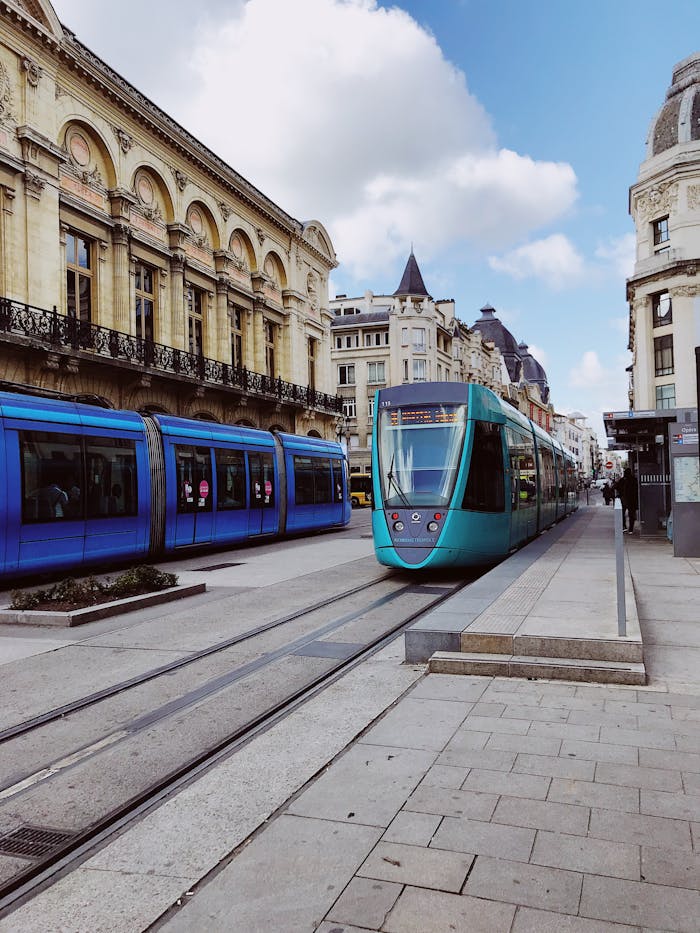 get-in-touch Colorful trams navigate the streets of Reims, France's historic city center, showcasing urban mobility.